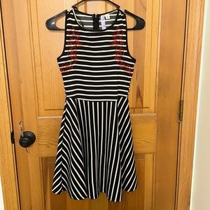 Size XS, only warn once, black and white striped Alya dress. Red floral details.